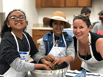 Woman and students cooking